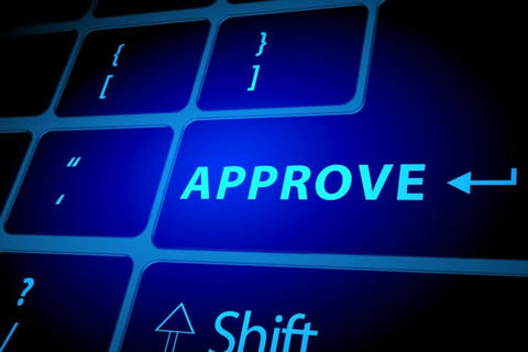"A close-up view of a keyboard with a blue glowing key labeled 'APPROVE,' symbolizing acceptance or authorization. Nearby keys include symbols for shift and brackets.